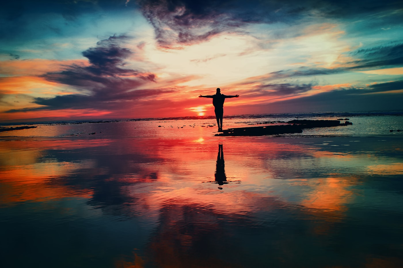 Woman in a yoga pose at sunset